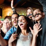 Groupe of people celebrating New Year's Eve and have Happy hour in a bar.  Coworkers and colleagues doing photo booths. Multiethnic group from 25 to 45 year’s old. Pictures was taken in Quebec Canada.